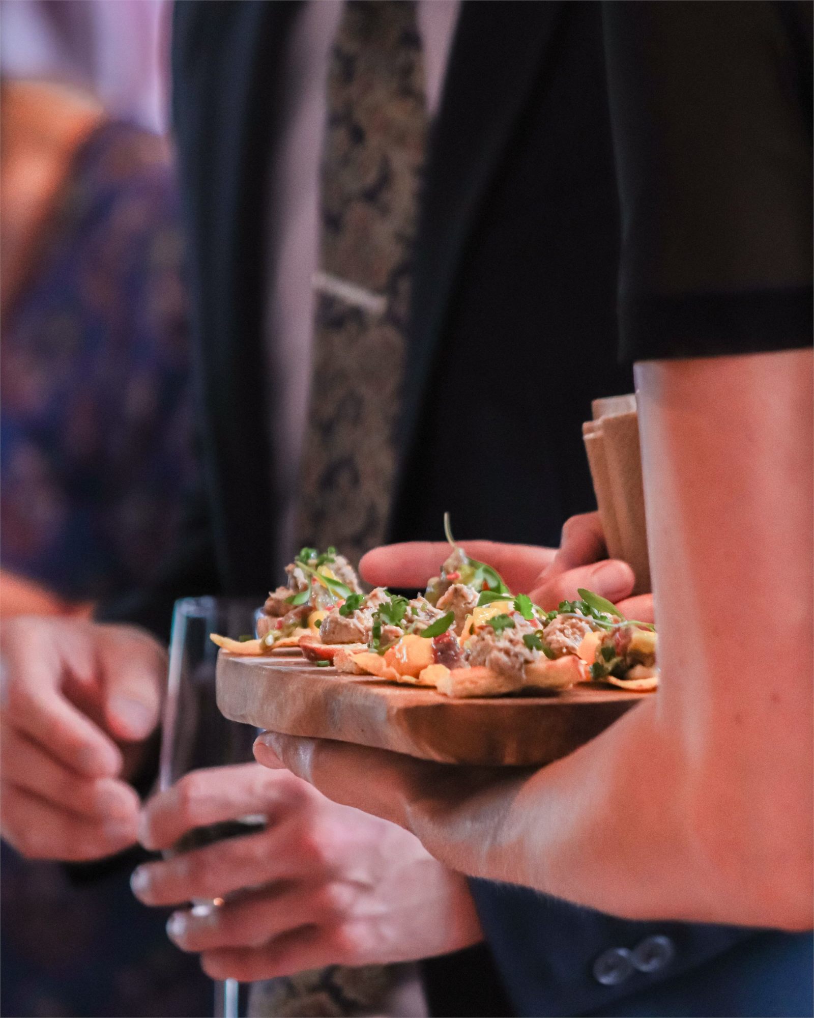 A tray of canapés carried between guests at a drinks reception