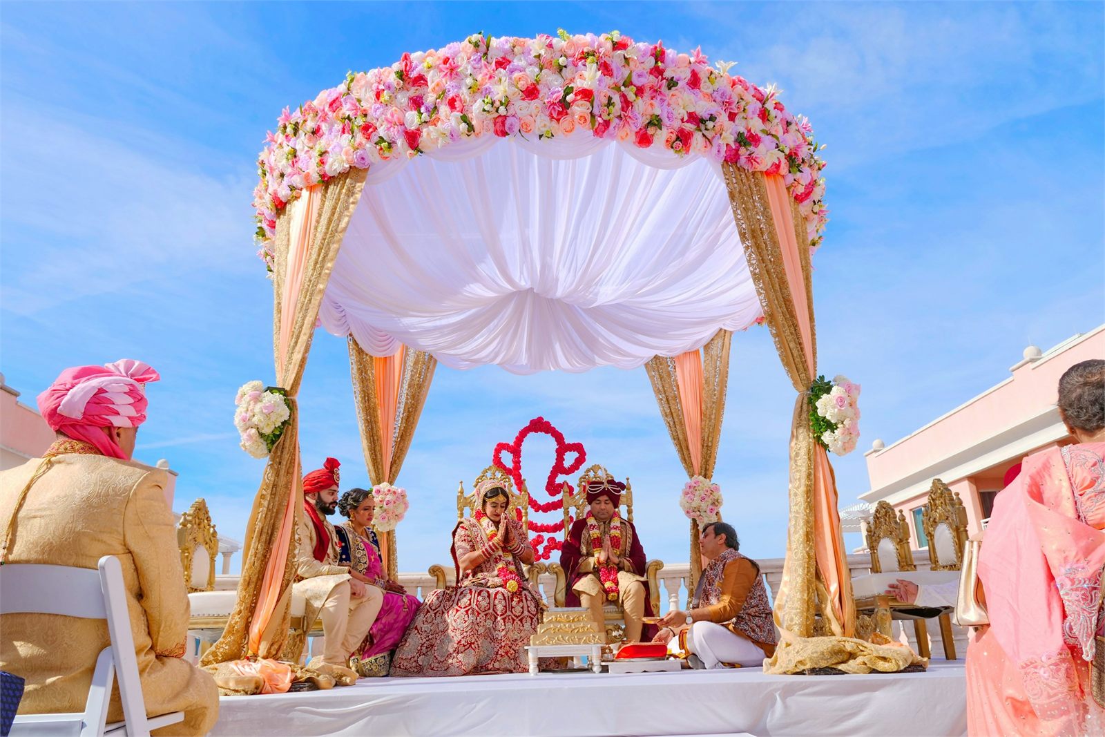 A ceremony taking place beneath a floral canopy