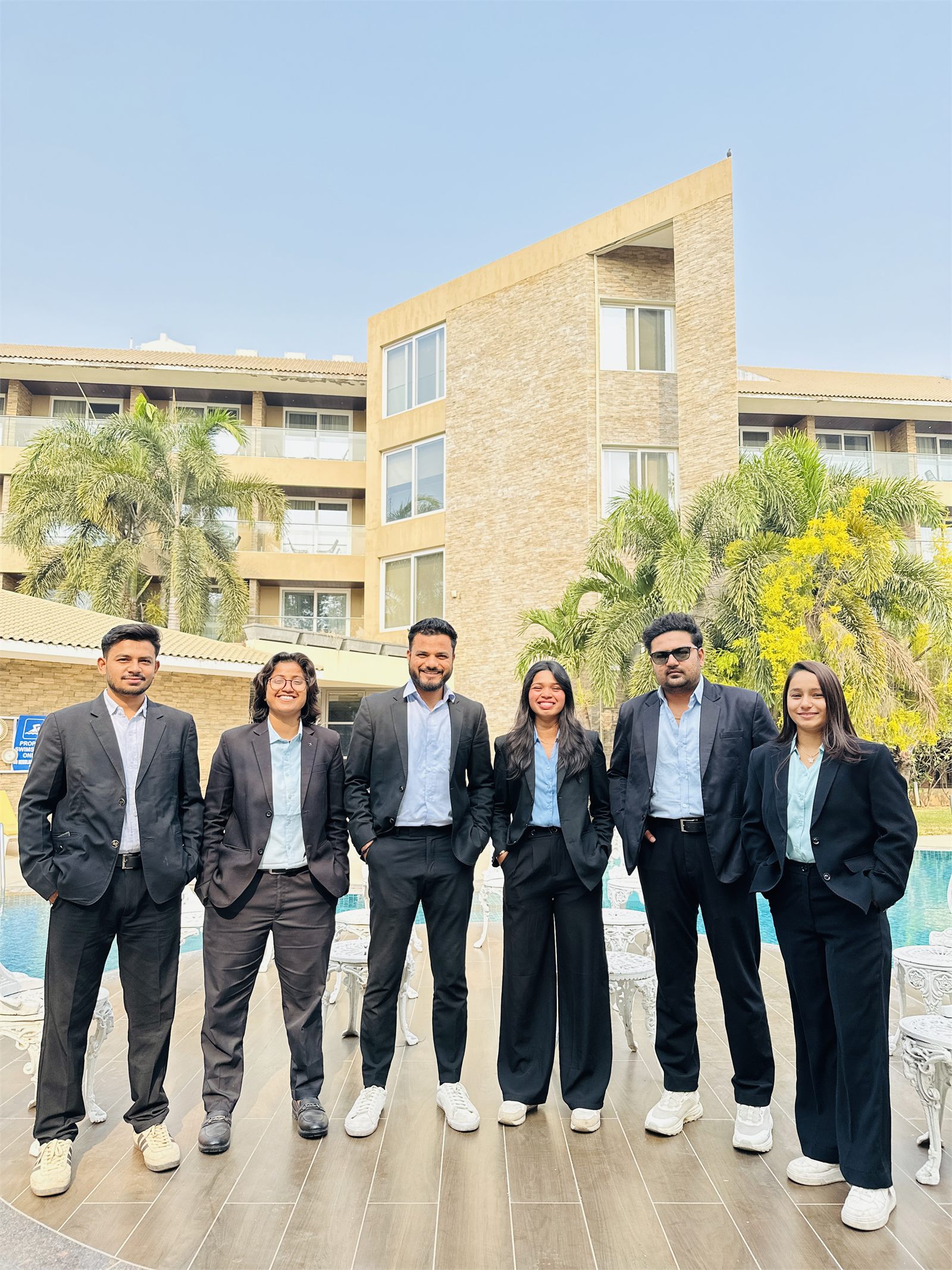The Indraa Events management crew in formal suits at a venue